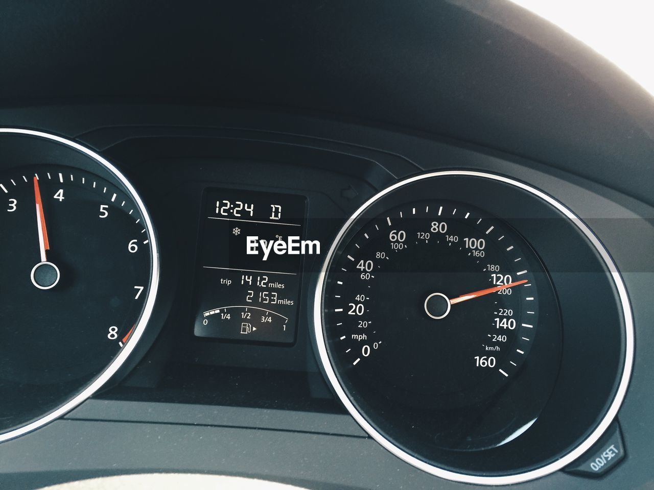 Close-up of car speedometer with fuel gauge