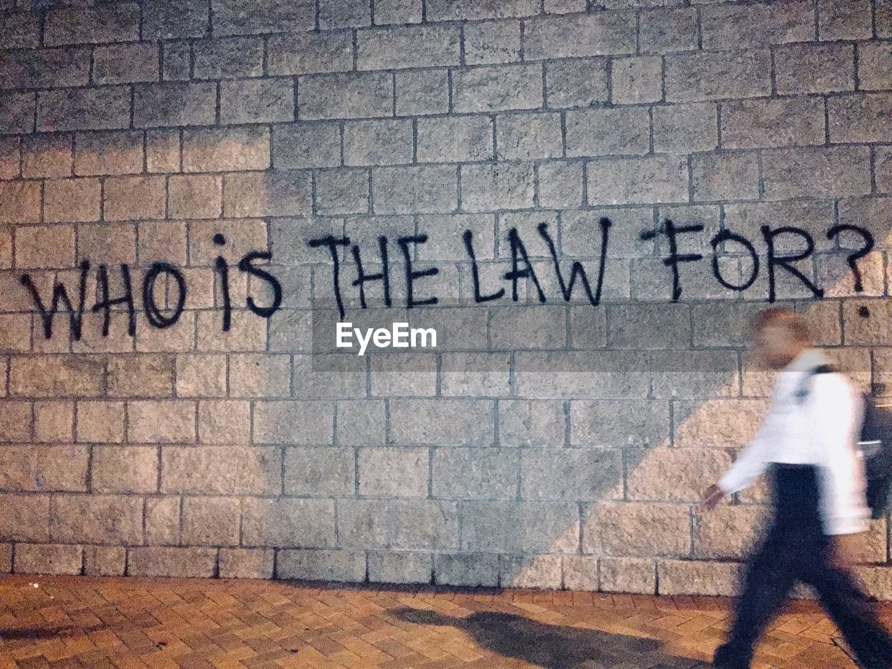 TEXT WRITTEN ON WALL BY GRAFFITI ON BRICK WALLS