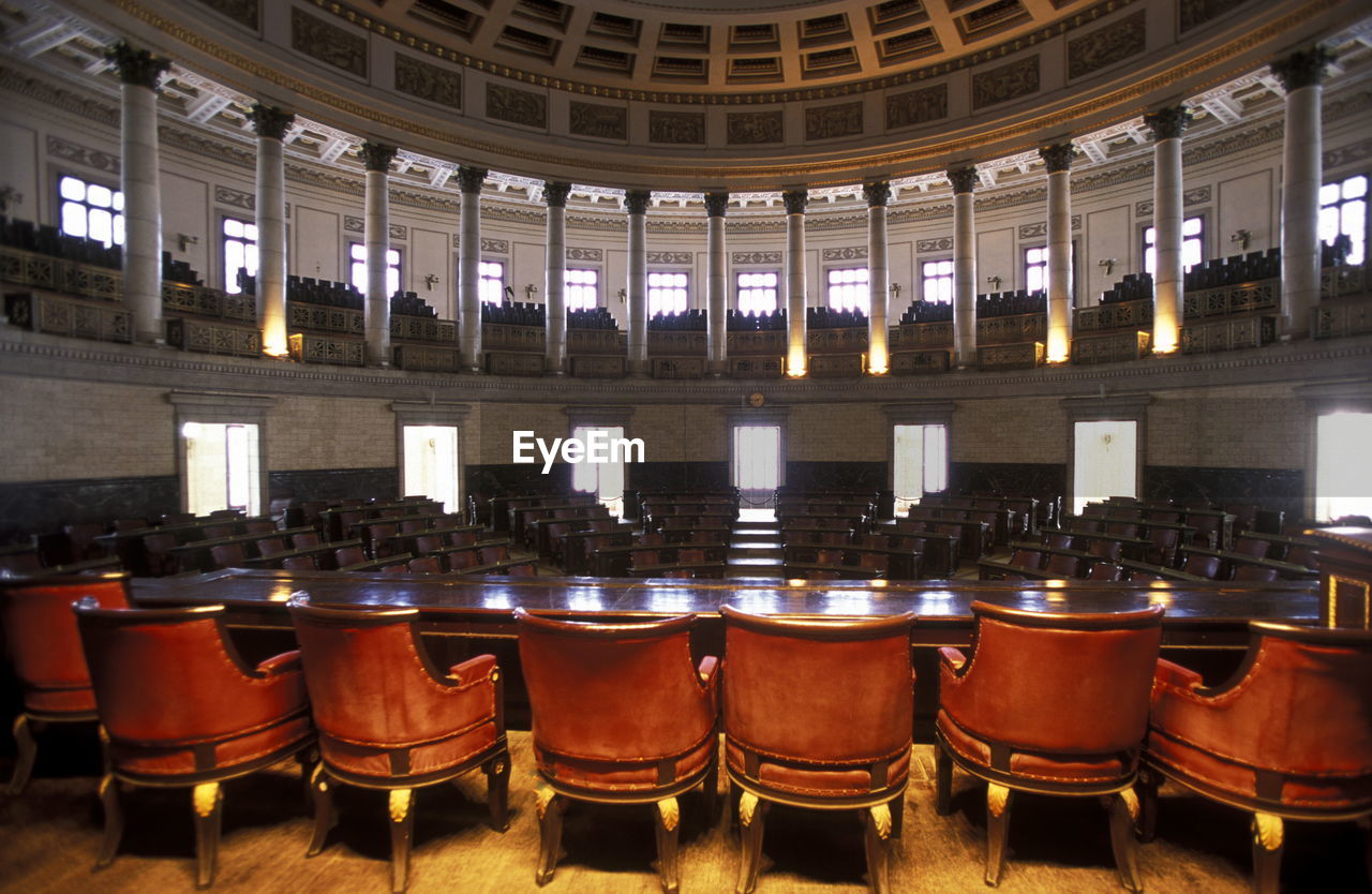 Empty chairs arranged in auditorium