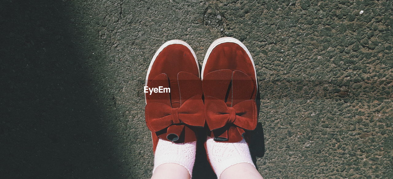 Low section of woman in shoes standing outdoors