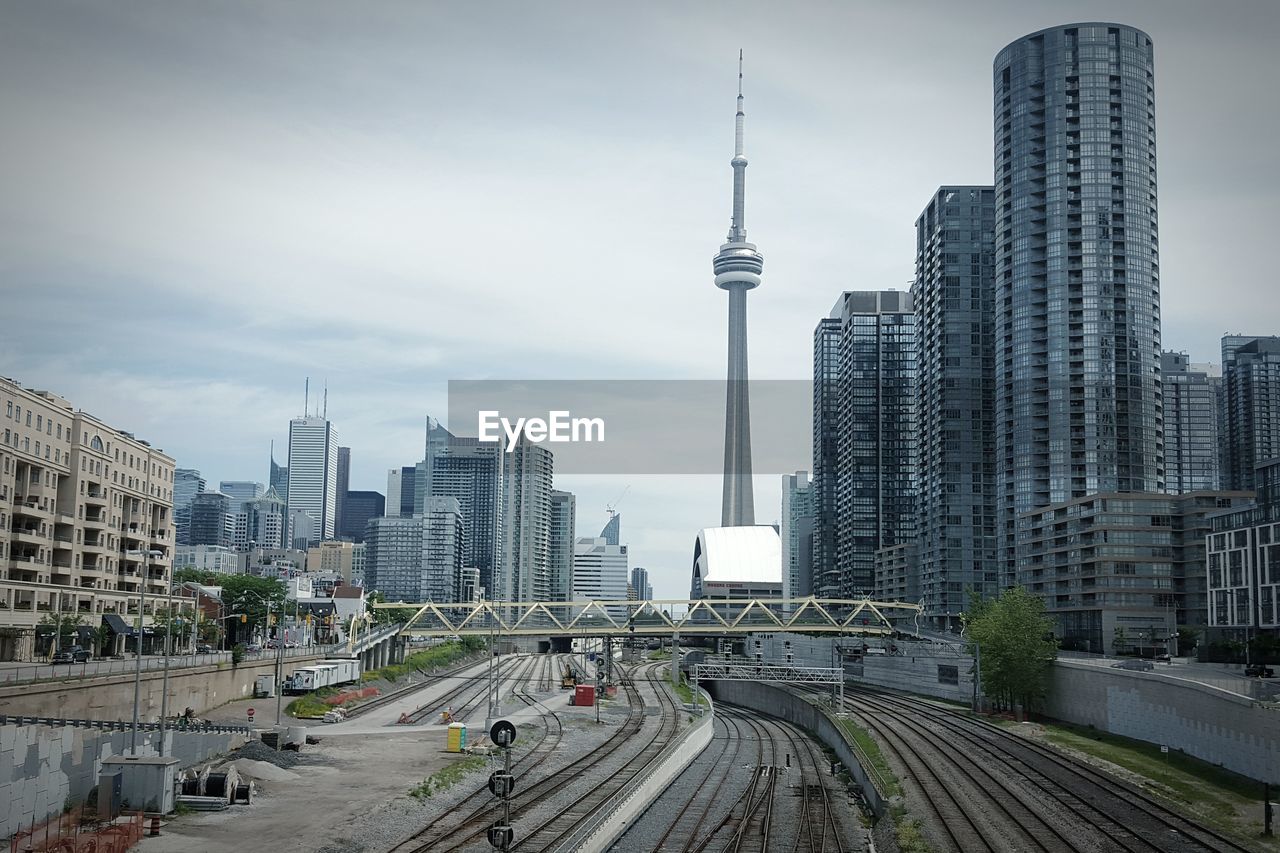 High angle view of railroad tracks against cn tower and buildings in city