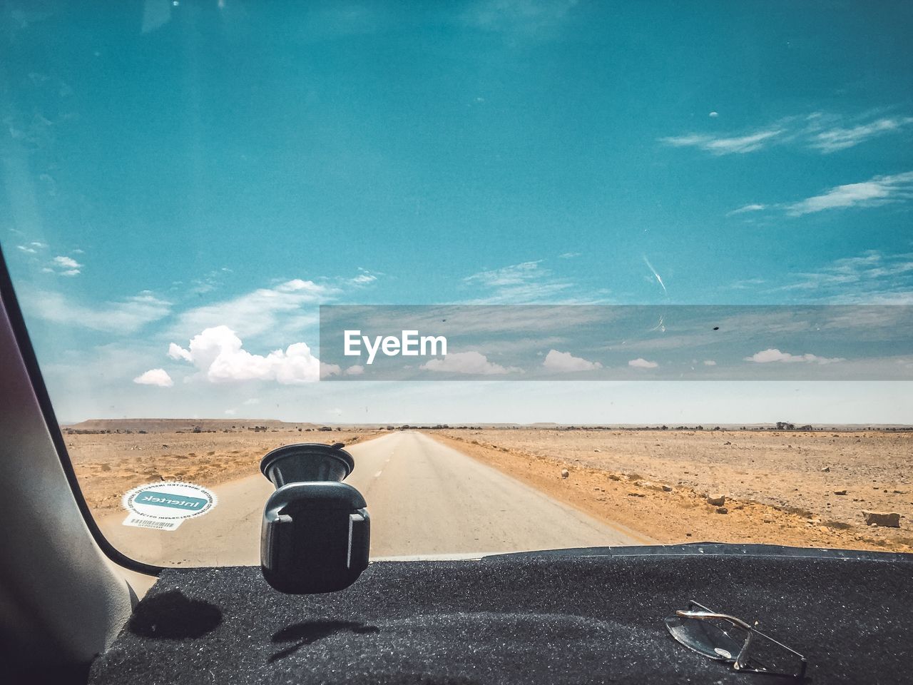 ROAD SEEN THROUGH WINDSHIELD