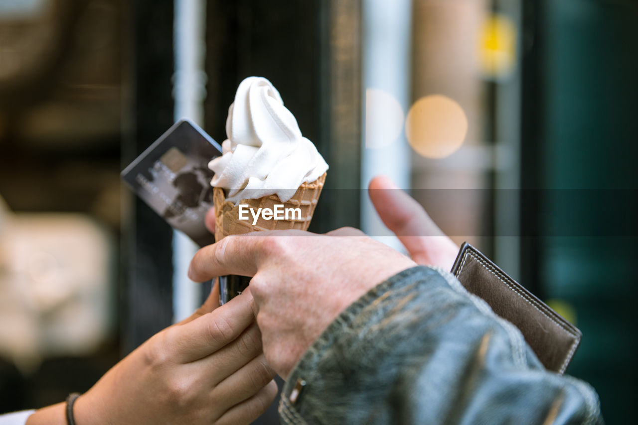 Close-up of hands holding ice cream