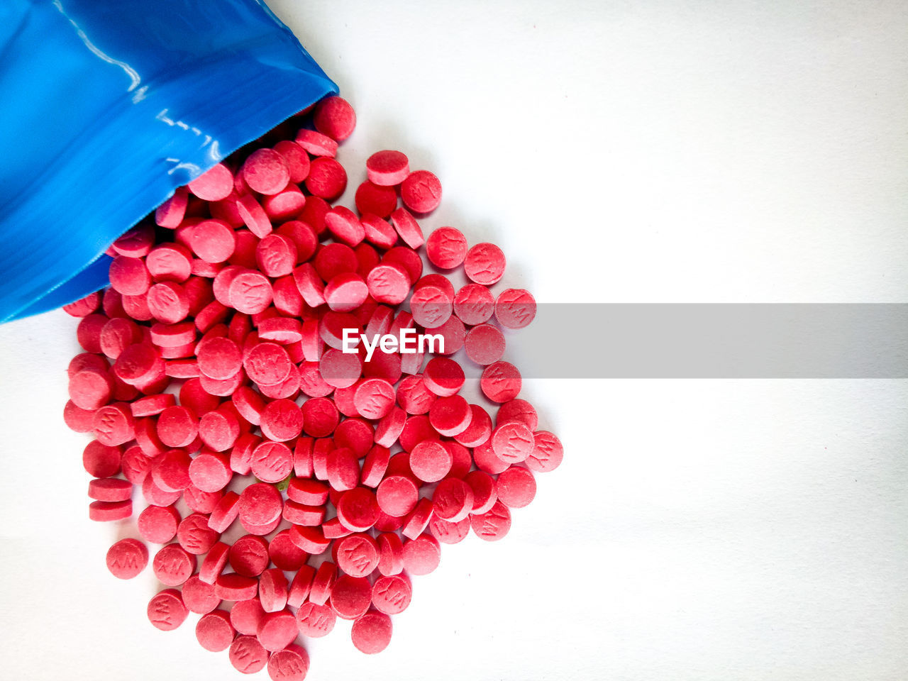 Directly above shot of red tablets over white background