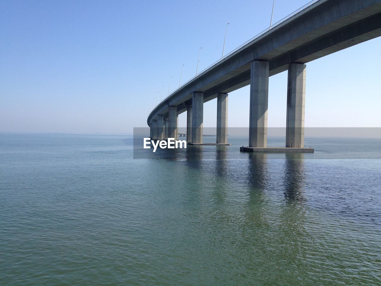 Low angle view of vasco da gama bridge over tagus river against clear sky