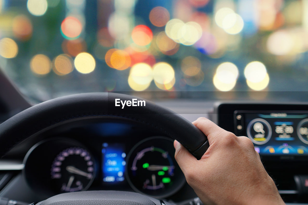 Close-up of person driving car