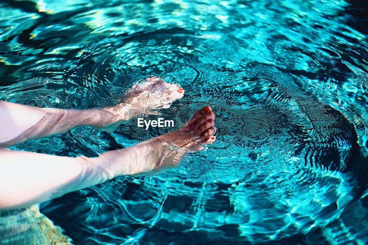 Low section of woman in swimming pool