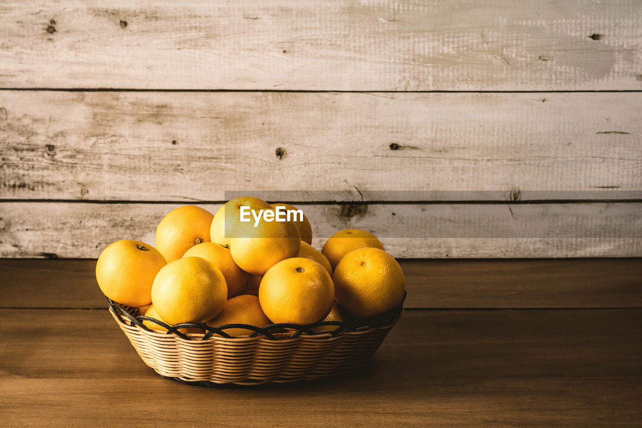 HIGH ANGLE VIEW OF FRUITS ON WOODEN TABLE