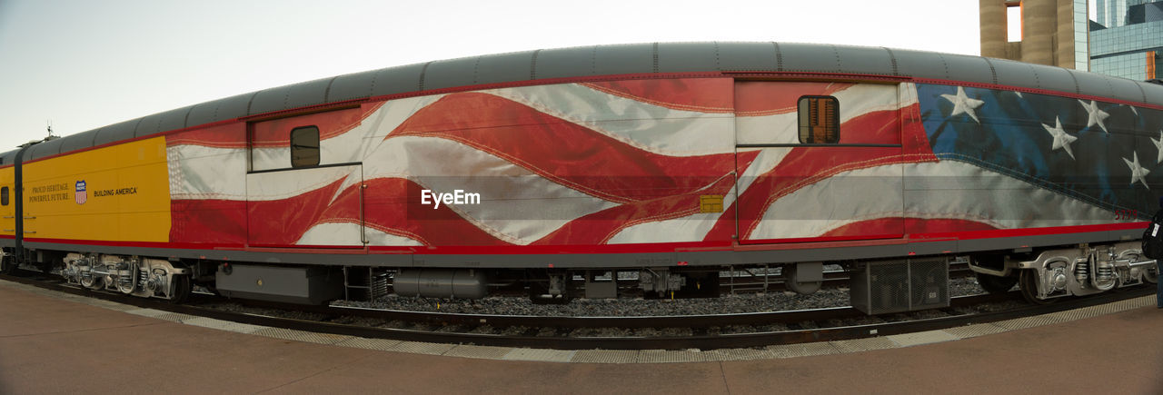 CLOSE-UP OF FLAG AGAINST RED WALL