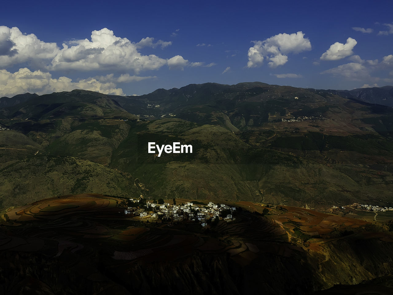 Scenic view of mountains against cloudy sky