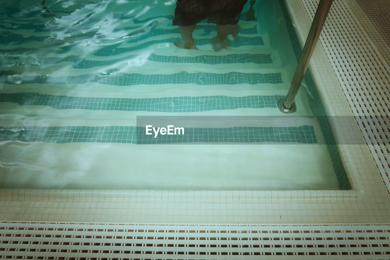 High angle view of person standing in swimming pool