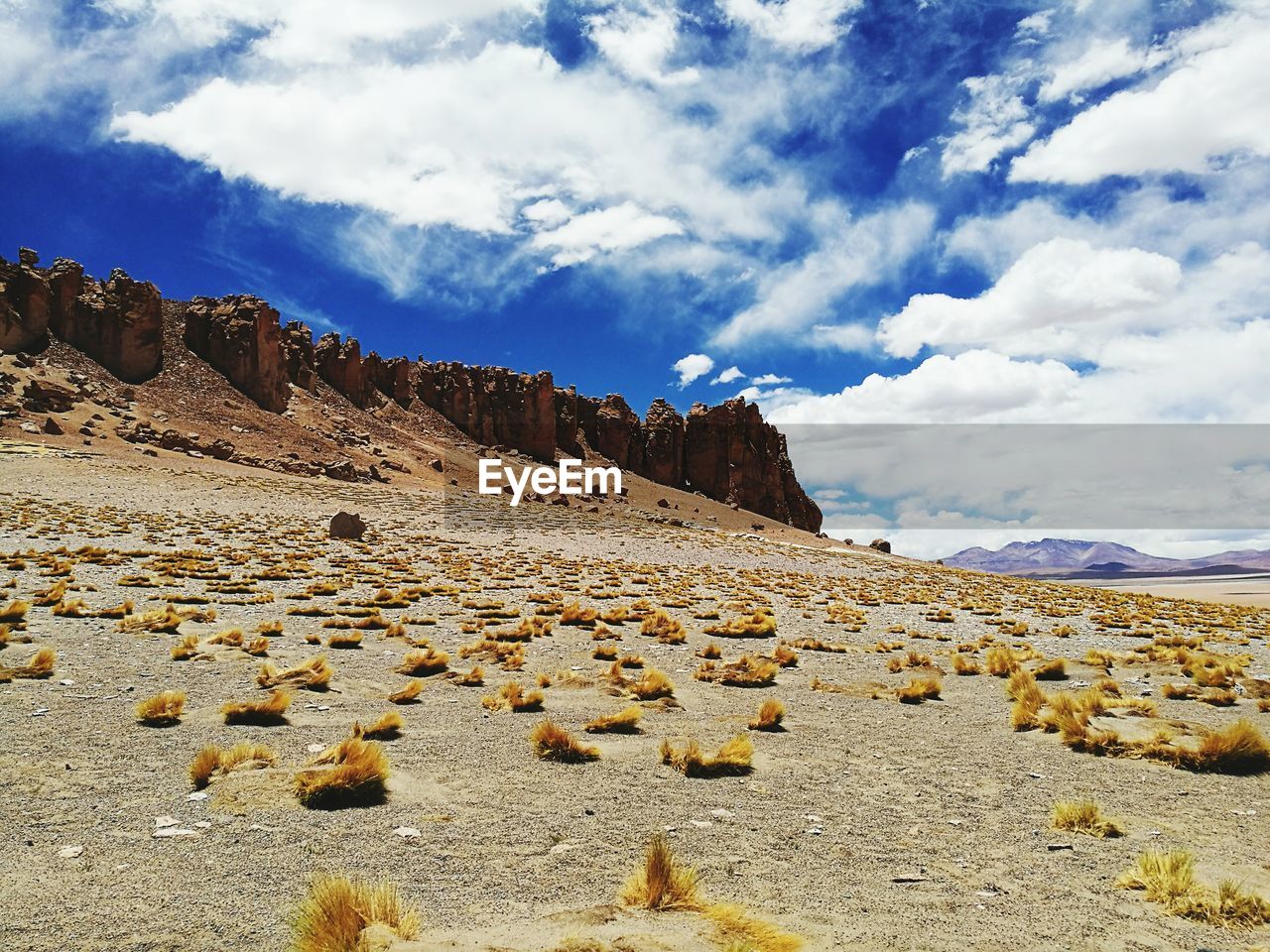 VIEW OF BEACH AGAINST CLOUDY SKY