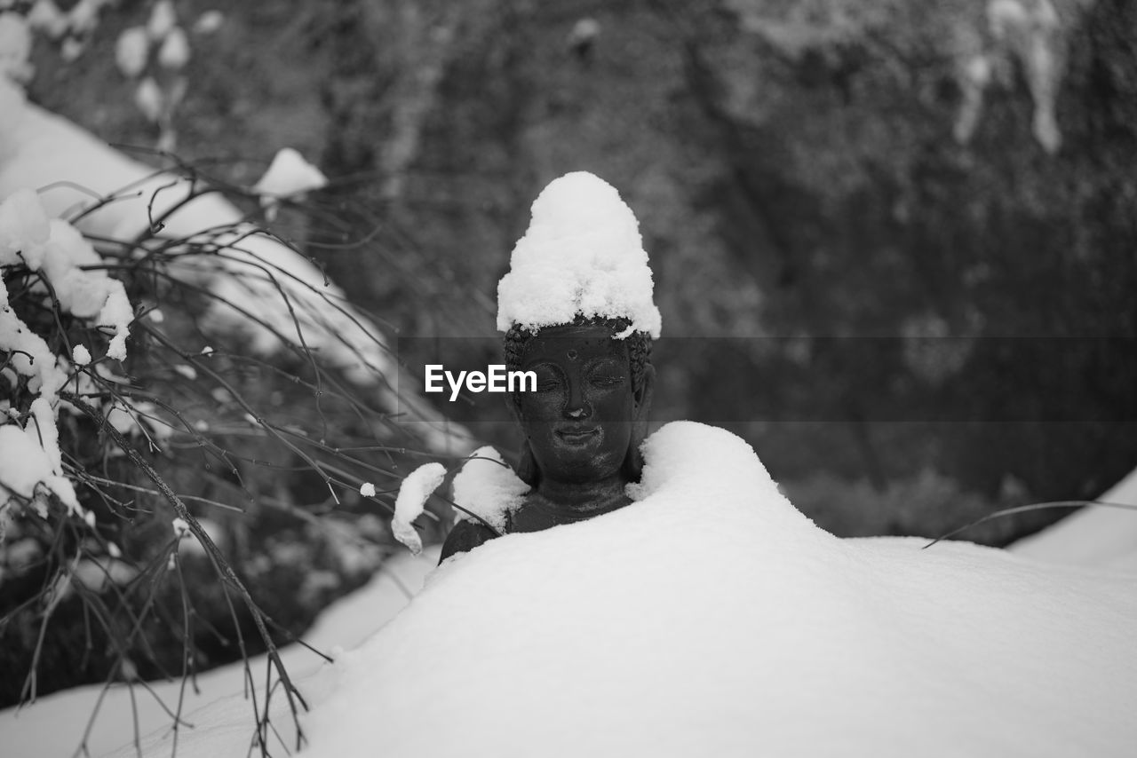 Woman covering face covered with snow