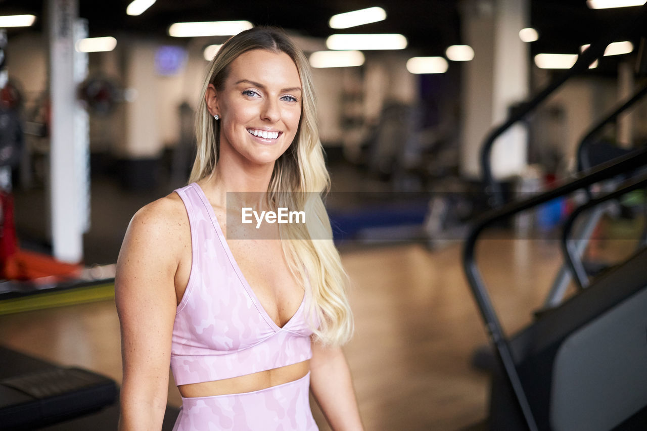 An indoor portrait of an athletic blonde woman.