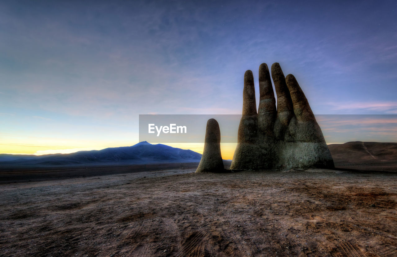Scenic view of desert against sky during sunset