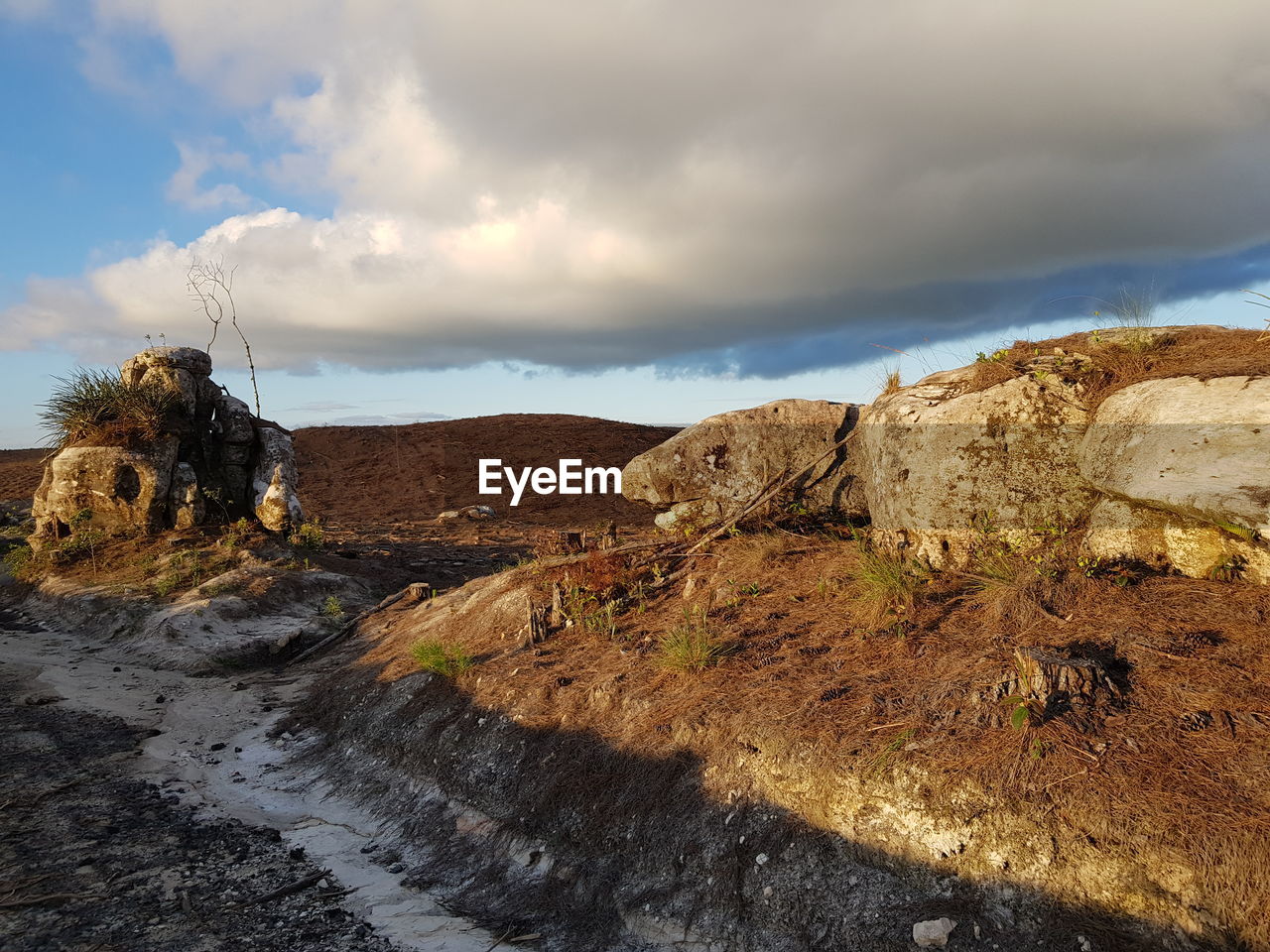 ROCK FORMATION ON LANDSCAPE AGAINST SKY