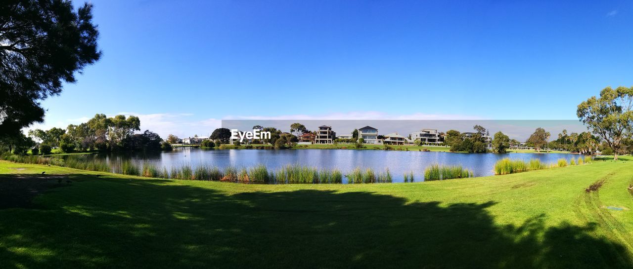 Scenic view of lake against clear blue sky