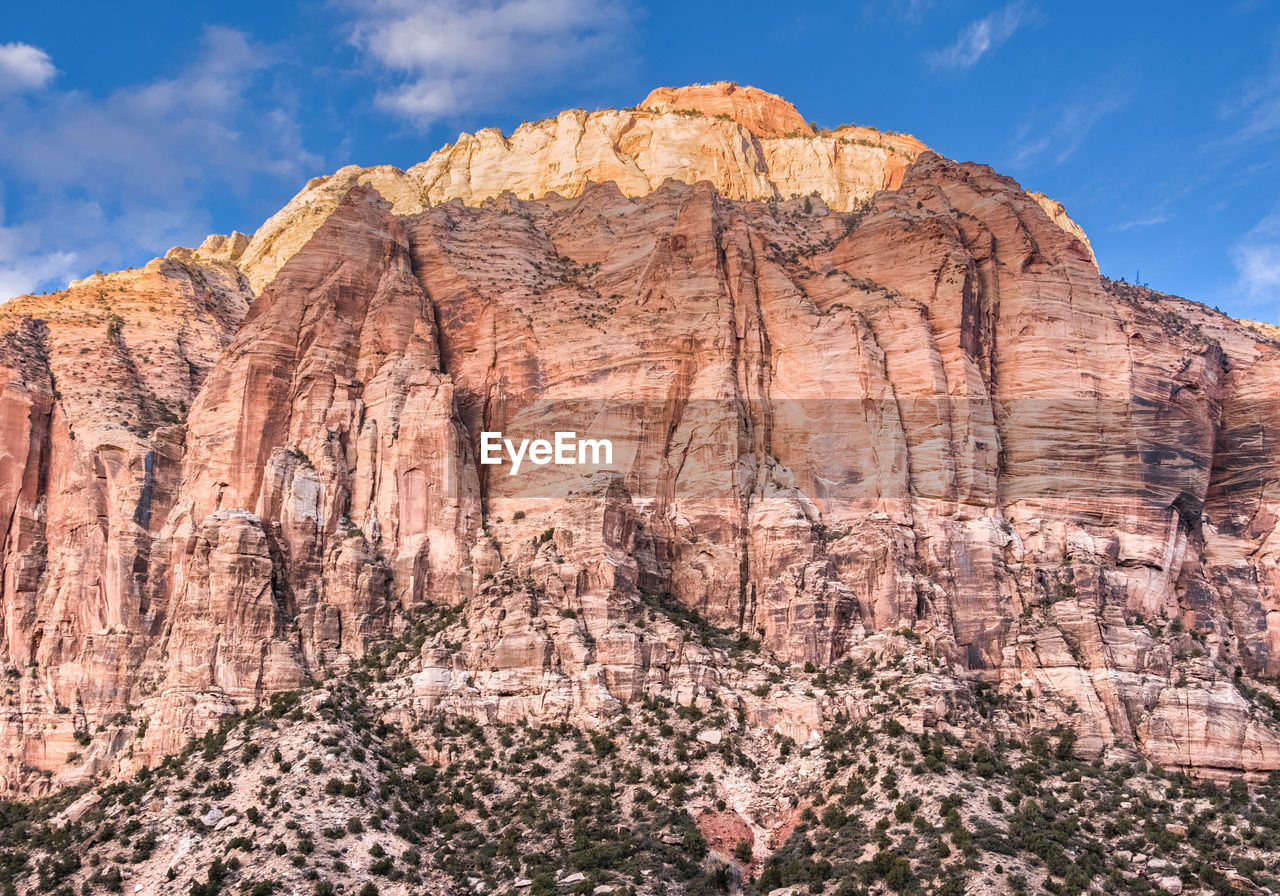 Low angle view of rock formations against blue sky