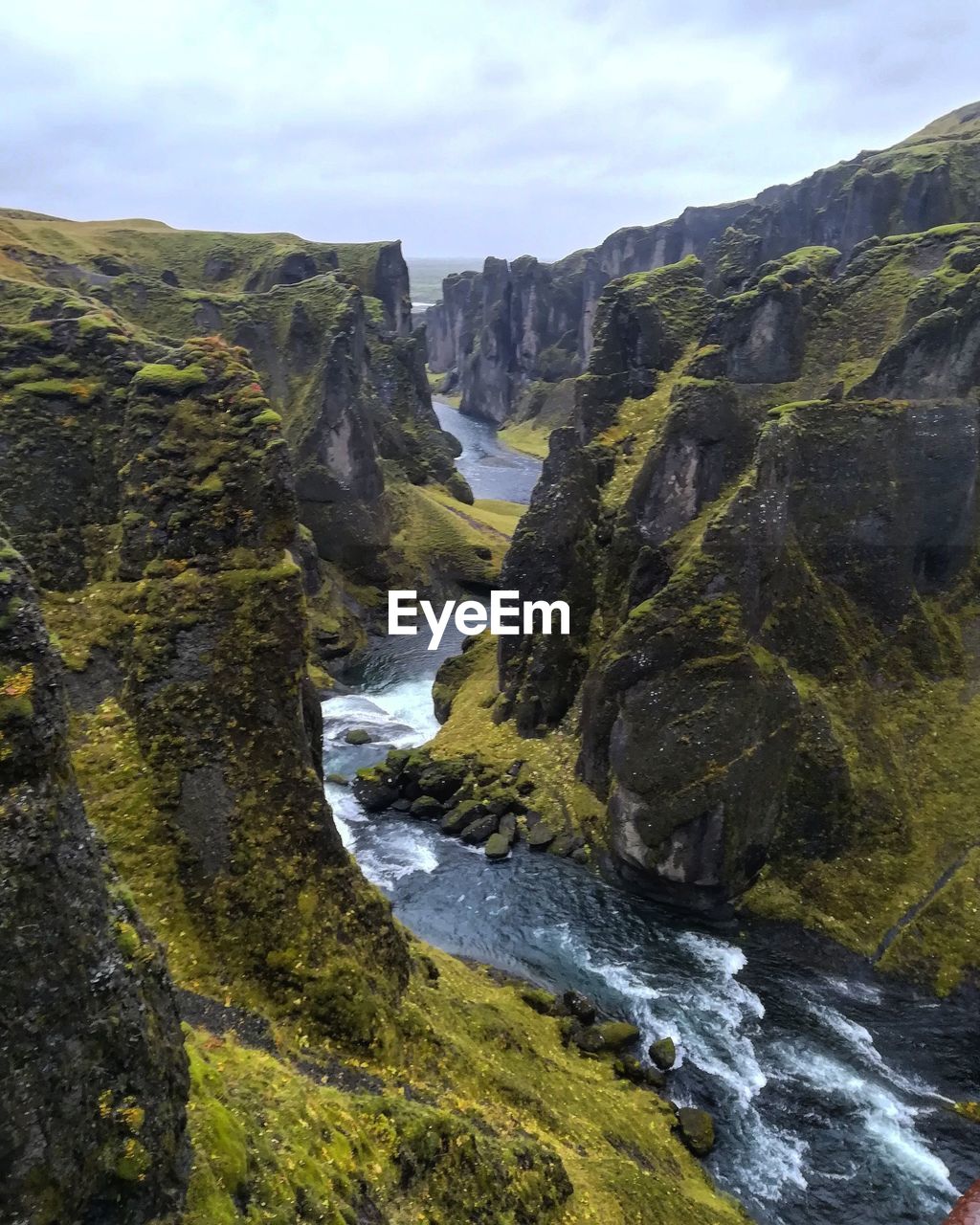 Scenic view of waterfall against sky