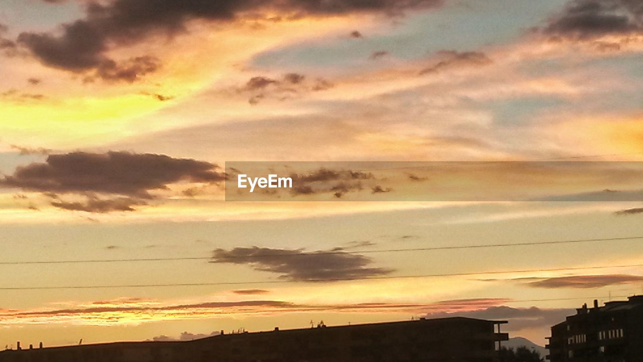 Buildings against sky during sunset