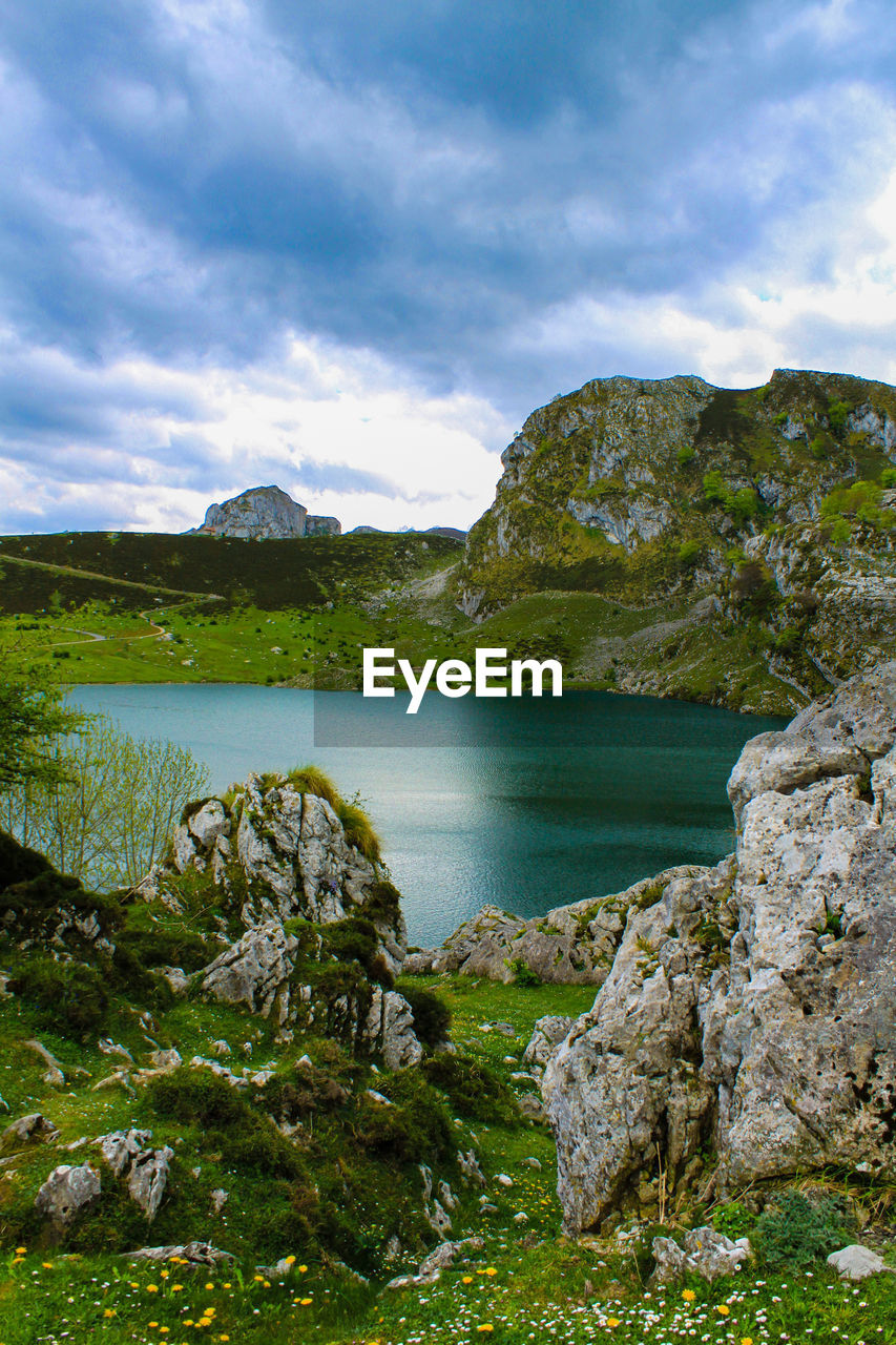 Scenic view of lake against cloudy sky