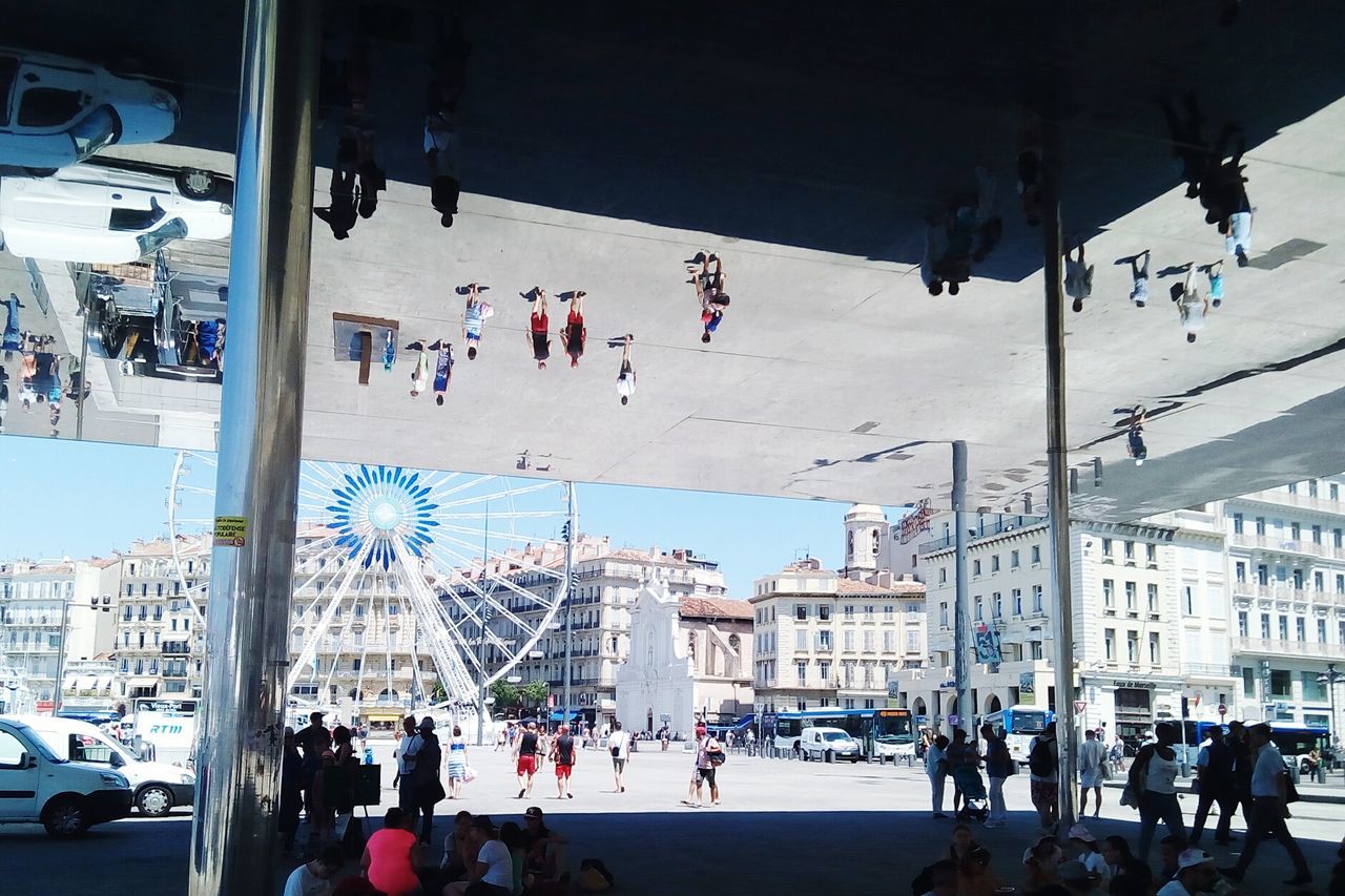 Reflection of people on ceiling in city