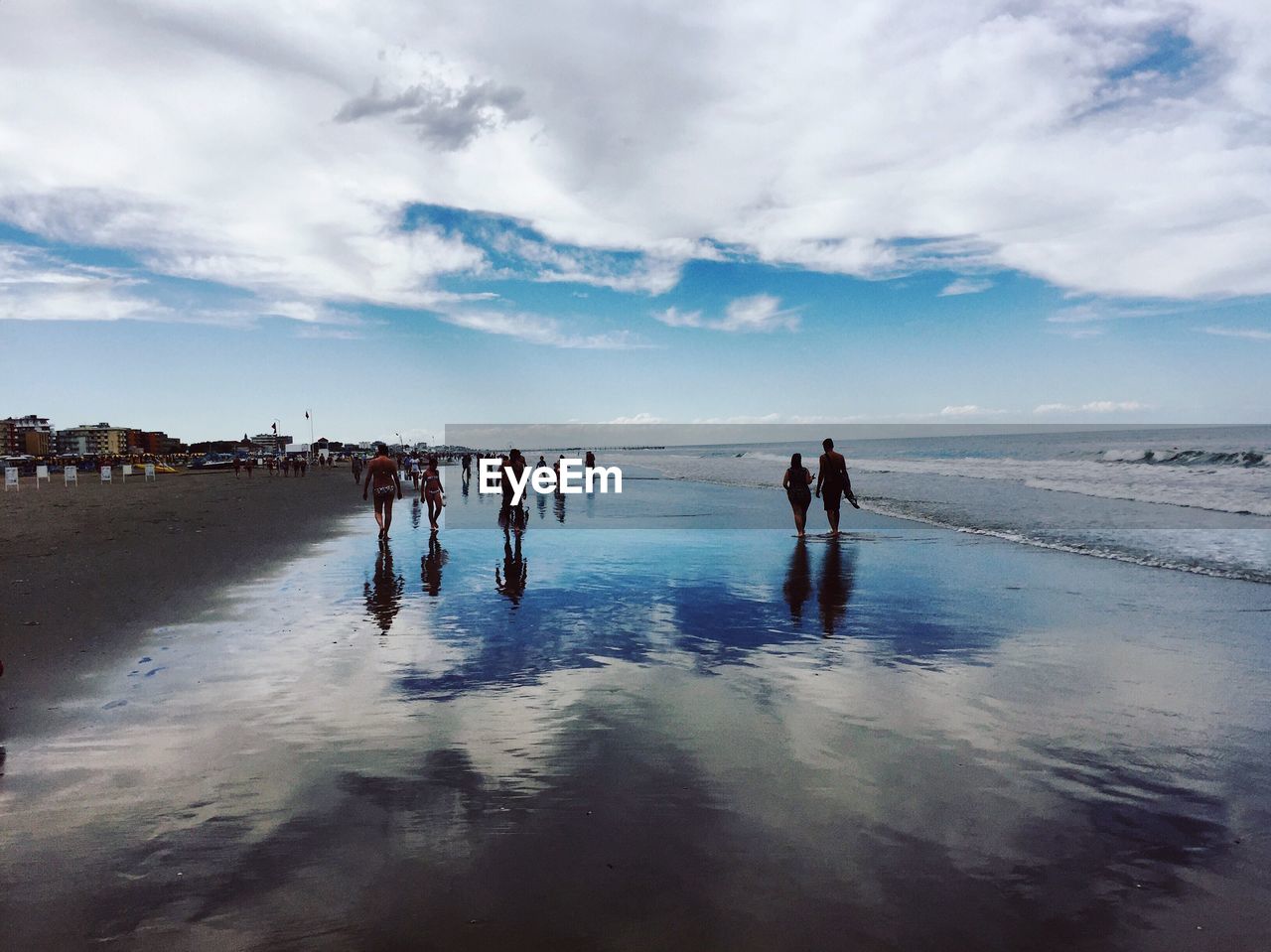 People on beach against sky