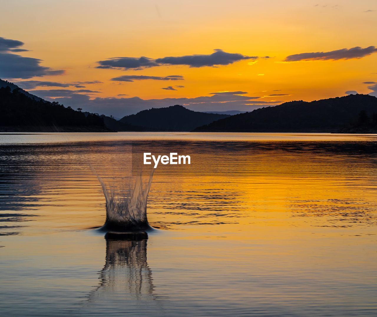 Scenic view of lake against sky during sunset
