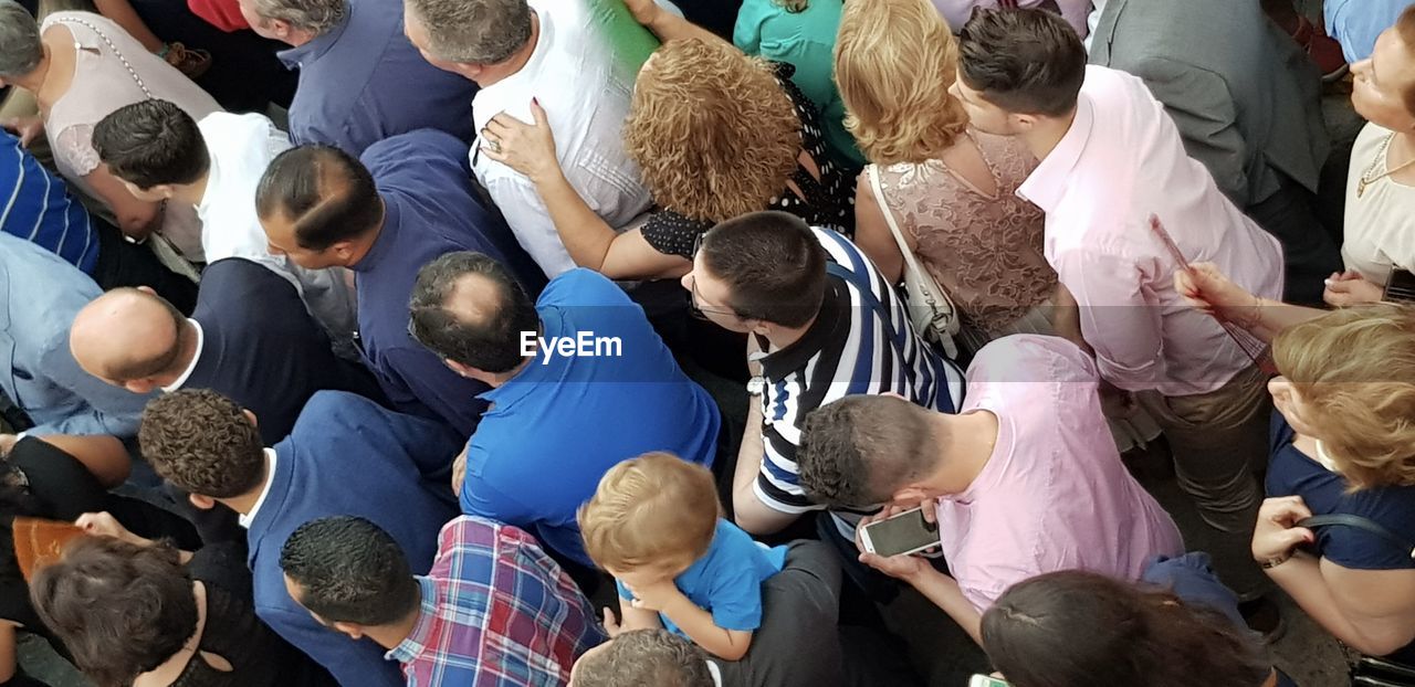 crowd, group of people, large group of people, audience, high angle view, men, adult, social group, education, women, togetherness, person, youth, clothing, communication, day, standing, looking