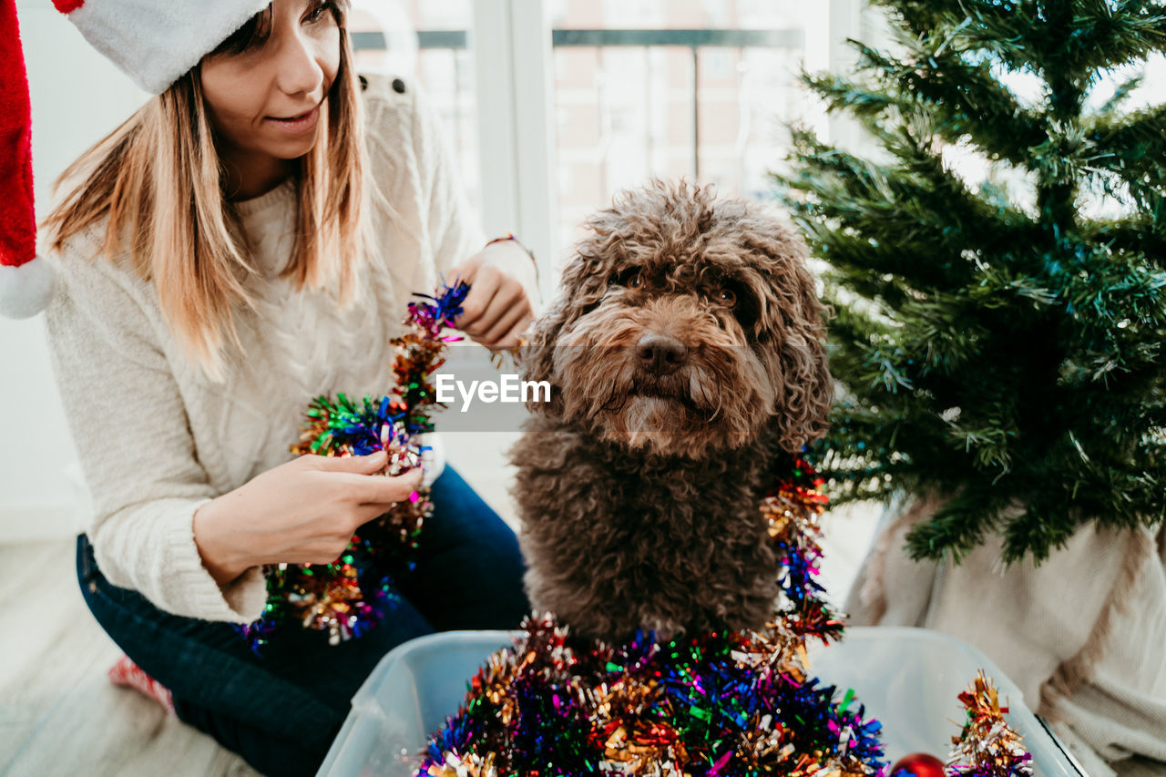 Woman with dog sitting at home