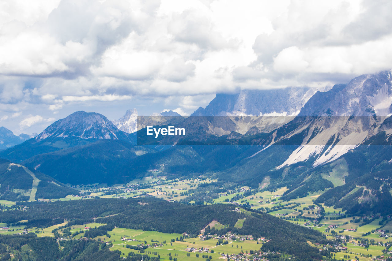 Scenic view of mountains against cloudy sky