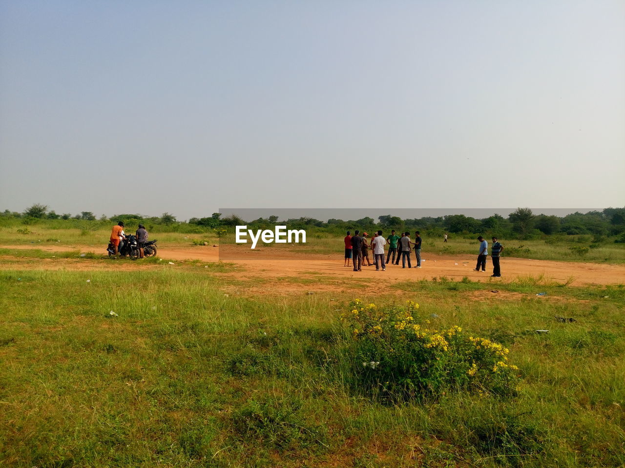 PEOPLE ON FARM AGAINST SKY