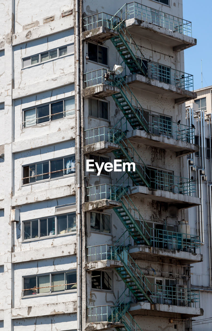 Low angle view of old building with fire escape