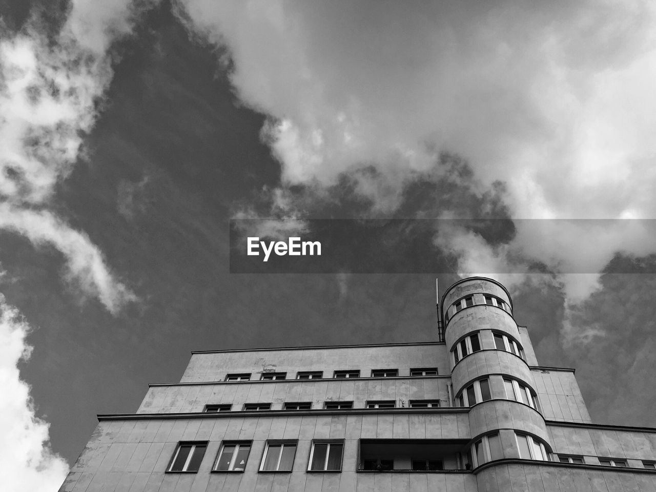 Low angle view of building against cloudy sky