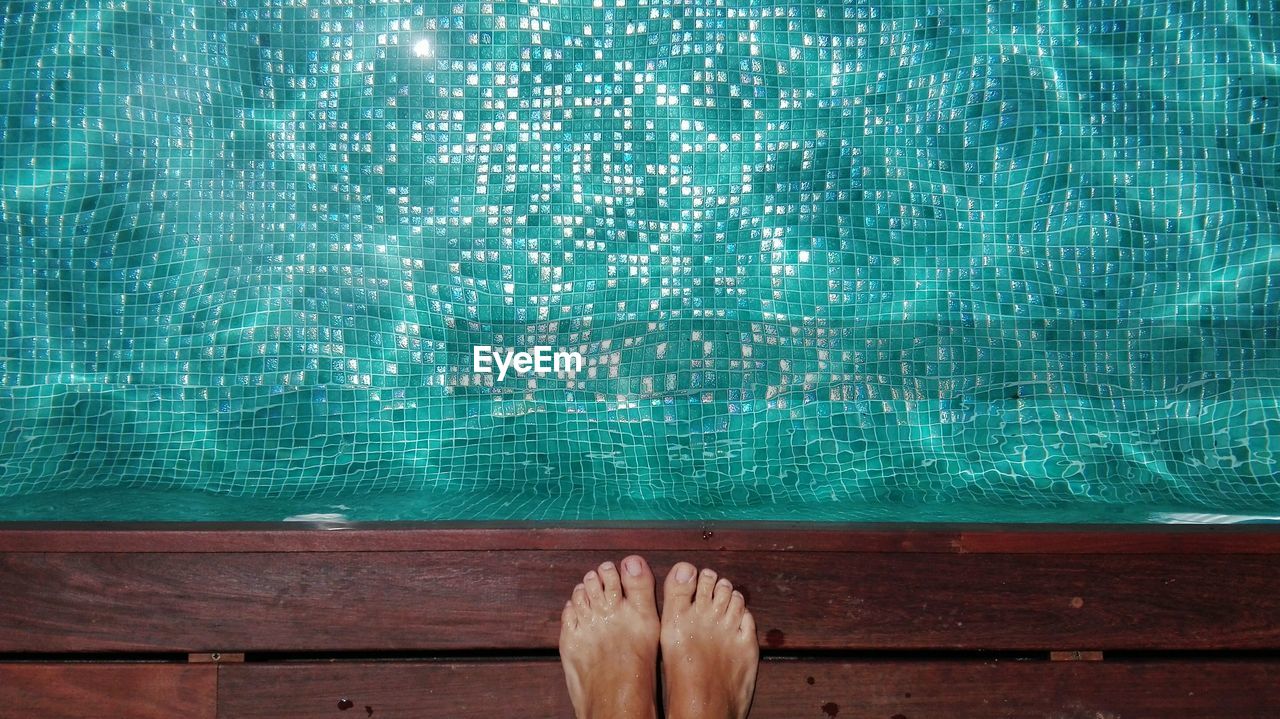 Low section of woman at swimming pool