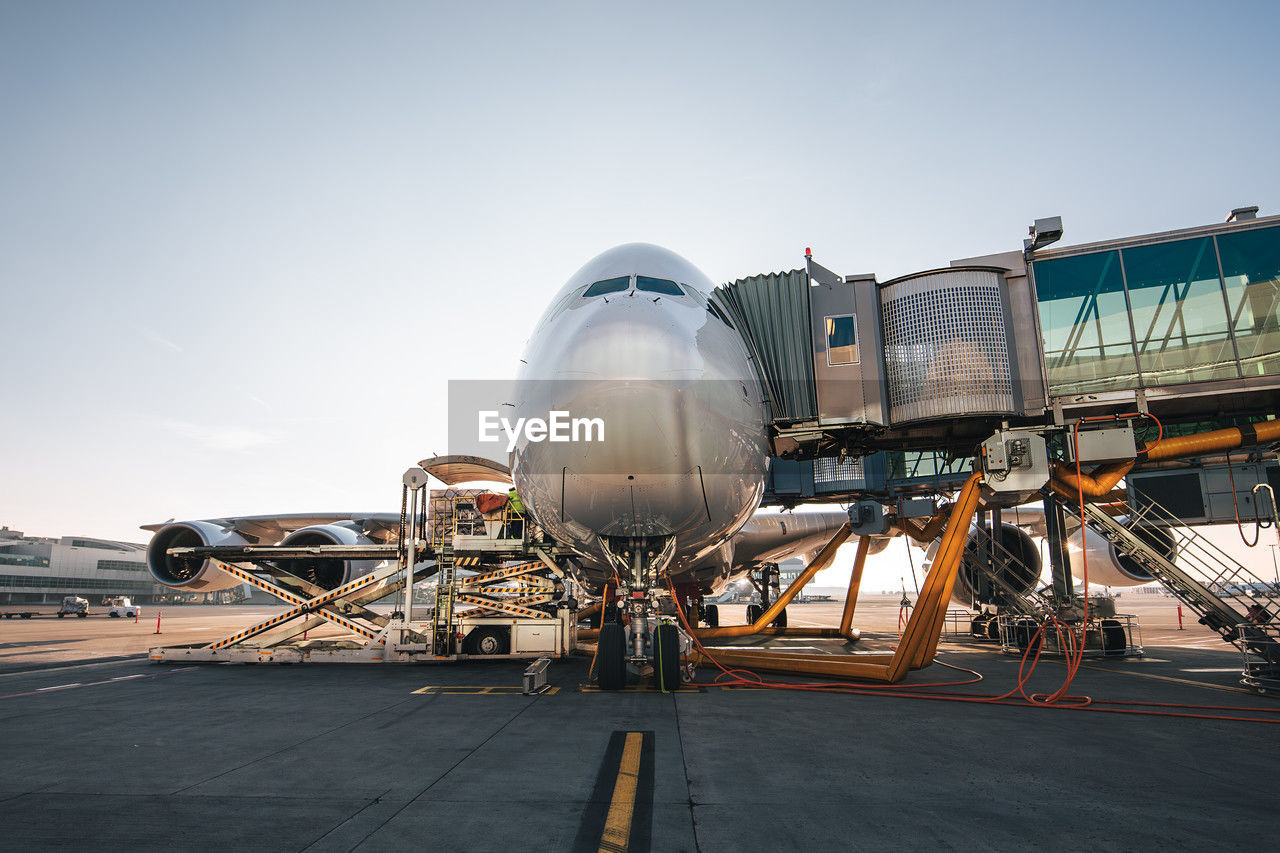 Loading of airplane before departure. front view of plane at airport on sunny day.