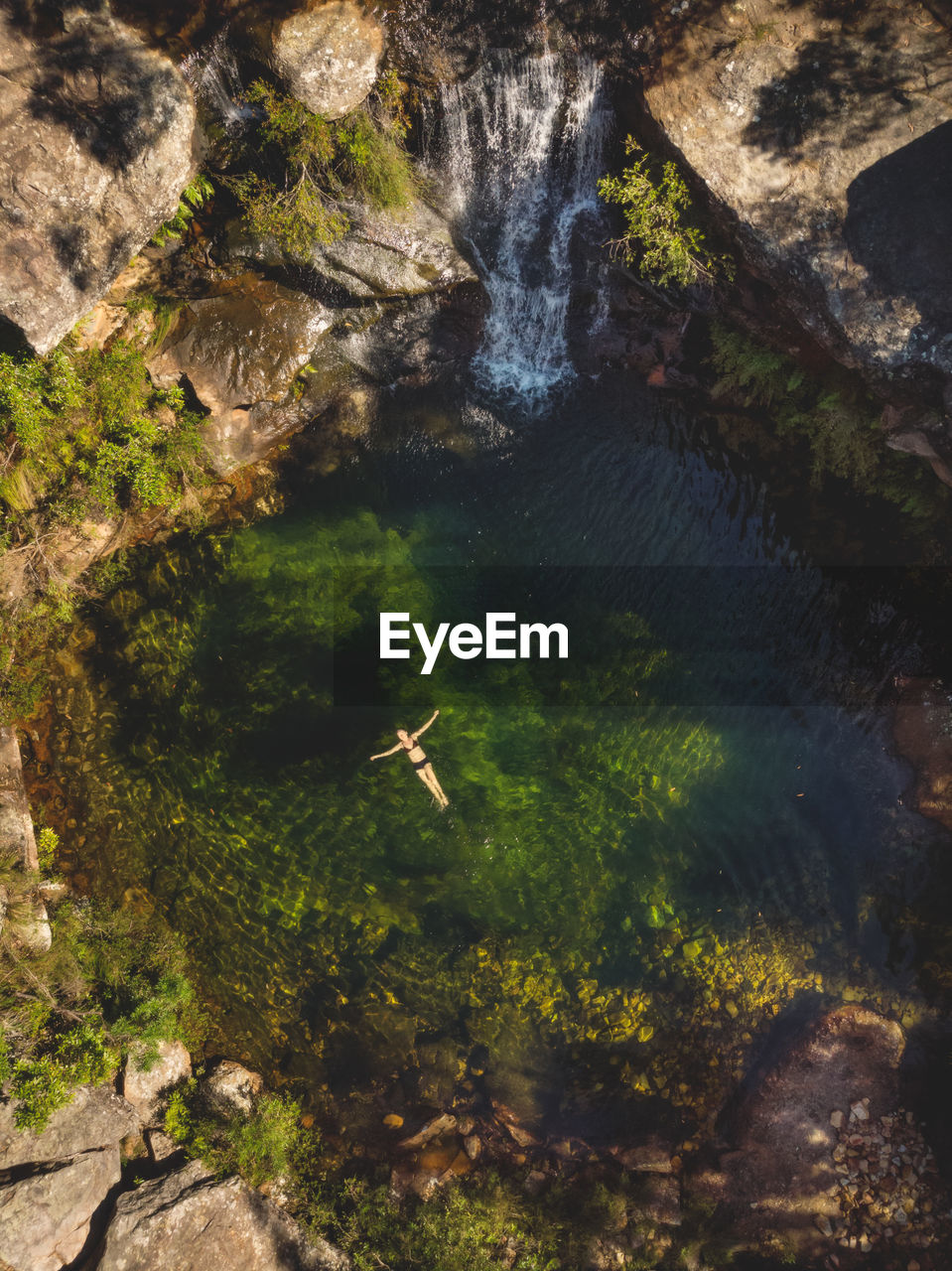 Aerial view of woman swimming in river