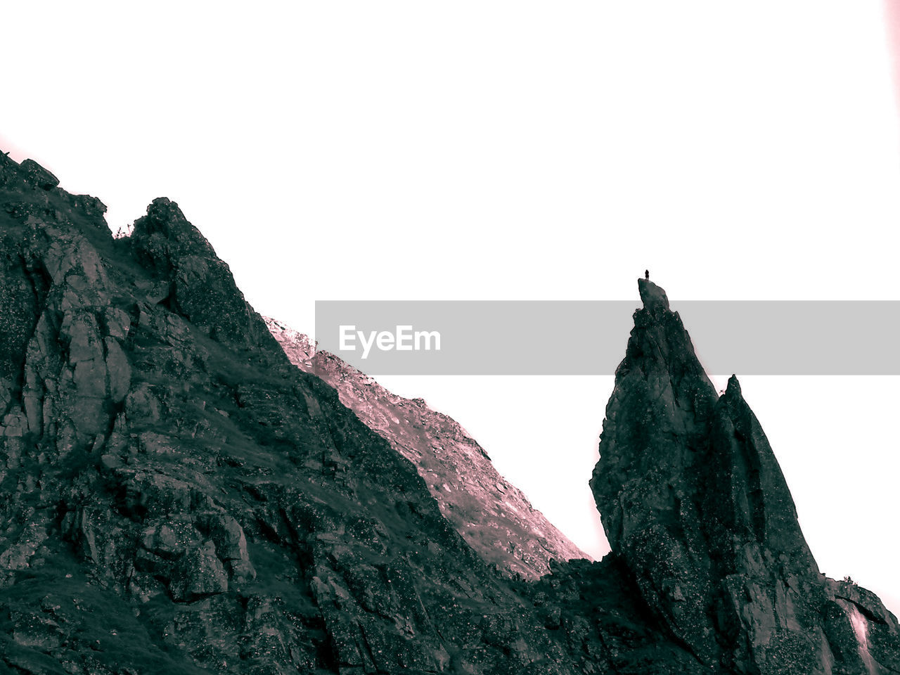 LOW ANGLE VIEW OF ROCKY MOUNTAINS AGAINST CLEAR SKY