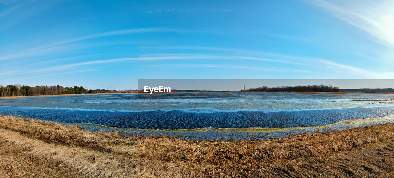 sky, horizon, water, shore, land, sea, nature, scenics - nature, beach, body of water, beauty in nature, coast, tranquility, blue, sand, landscape, ocean, wave, environment, tranquil scene, reflection, cloud, no people, travel destinations, sunlight, plant, day, travel, outdoors, morning, tree, dusk, bay, summer, idyllic, coastline, tourism, sunny, clear sky, non-urban scene