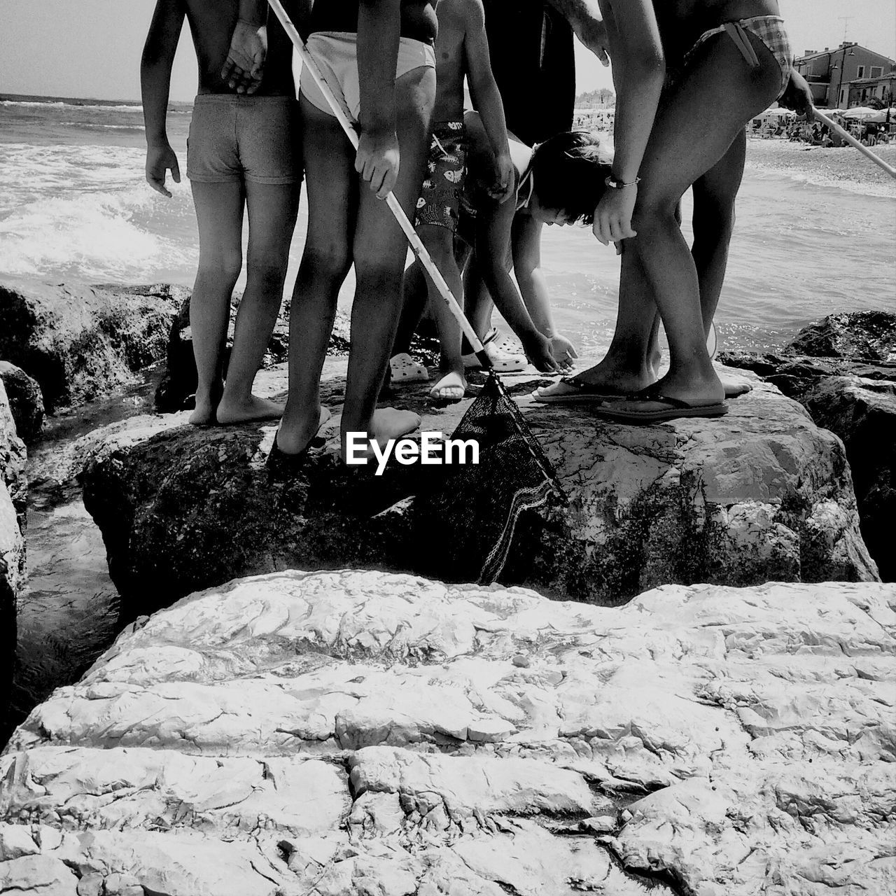 Group of friends on beach rock