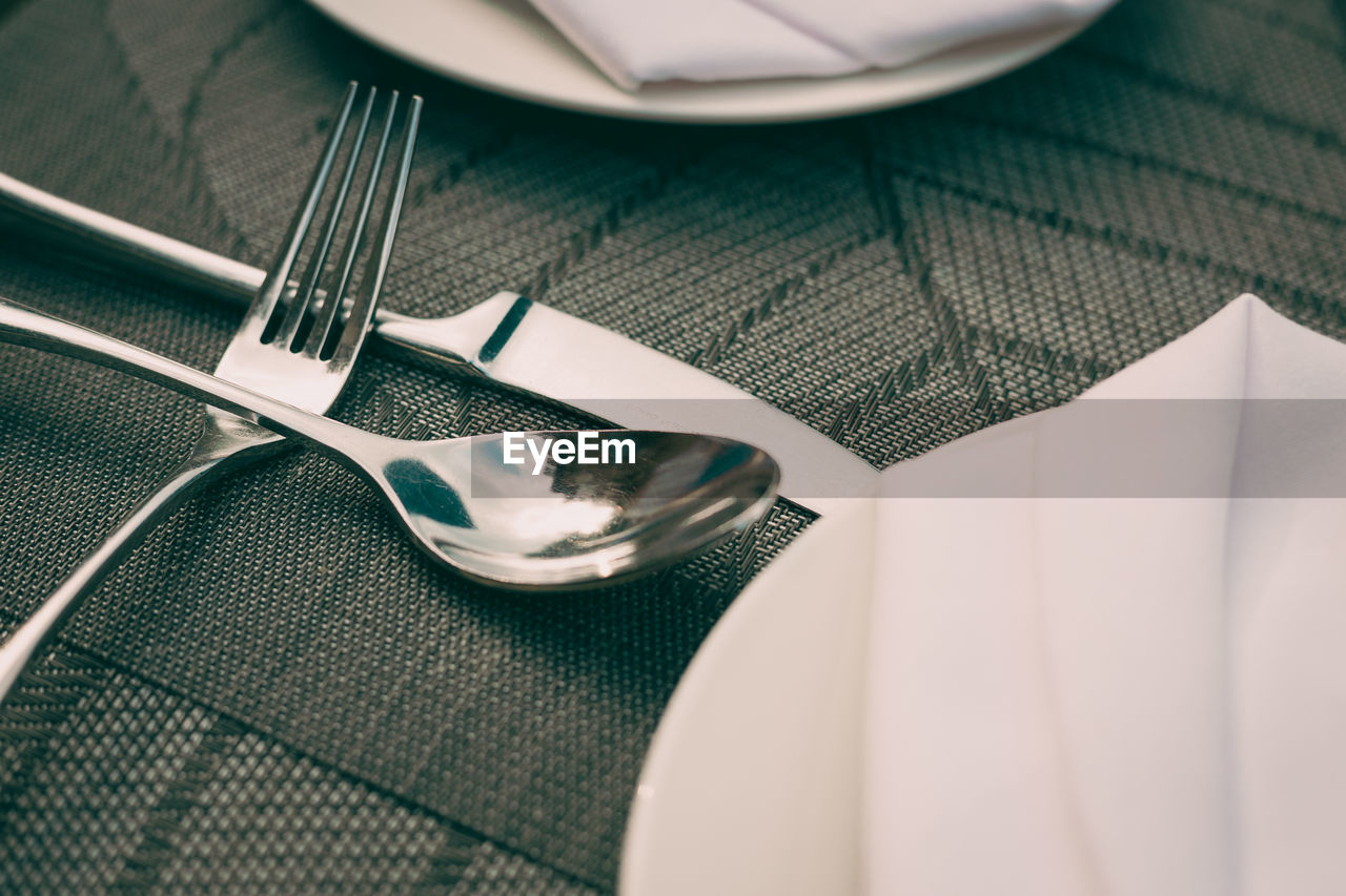High angle view of cutlery on dining table