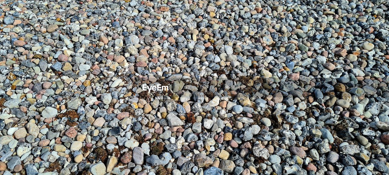 abundance, full frame, backgrounds, large group of objects, gravel, pebble, stone, no people, rock, day, asphalt, nature, outdoors, high angle view, land, road surface, textured, rubble, beach