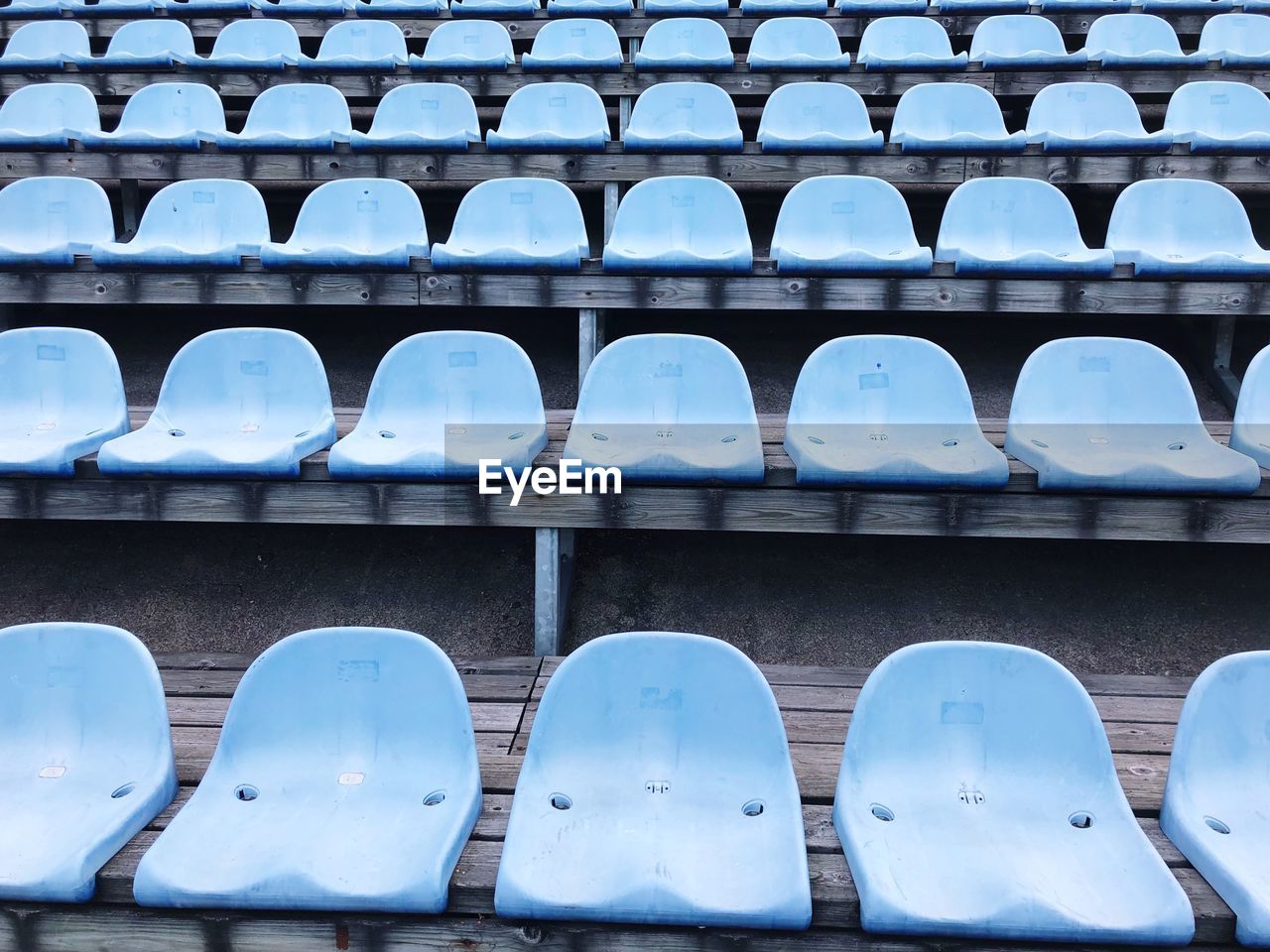 Full frame shot of empty chairs at stadium