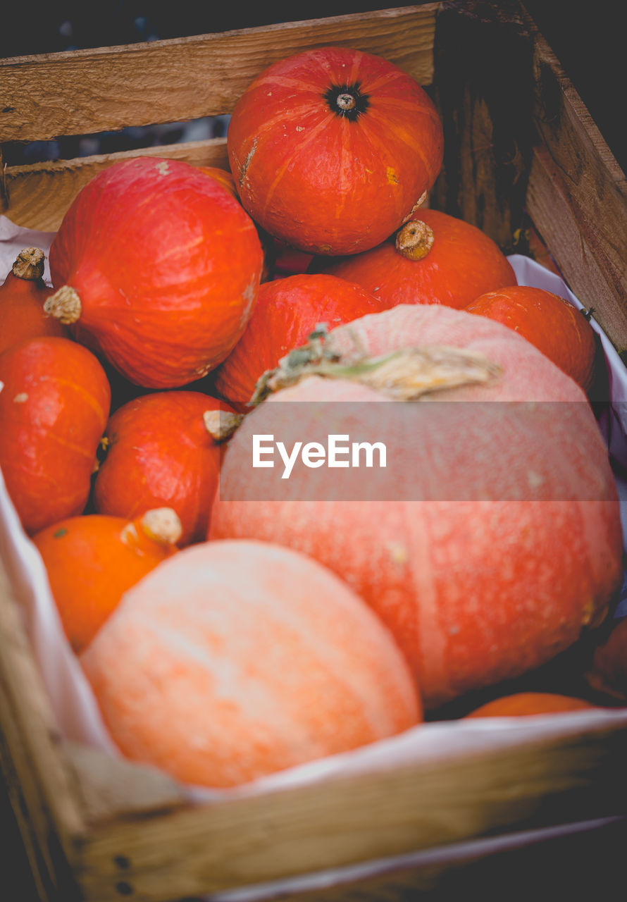 Close-up of pumpkins in basket for sale at market