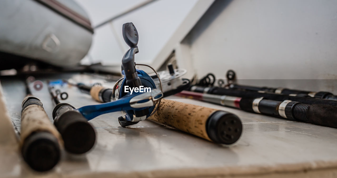 Close-up of various fishing rods on table