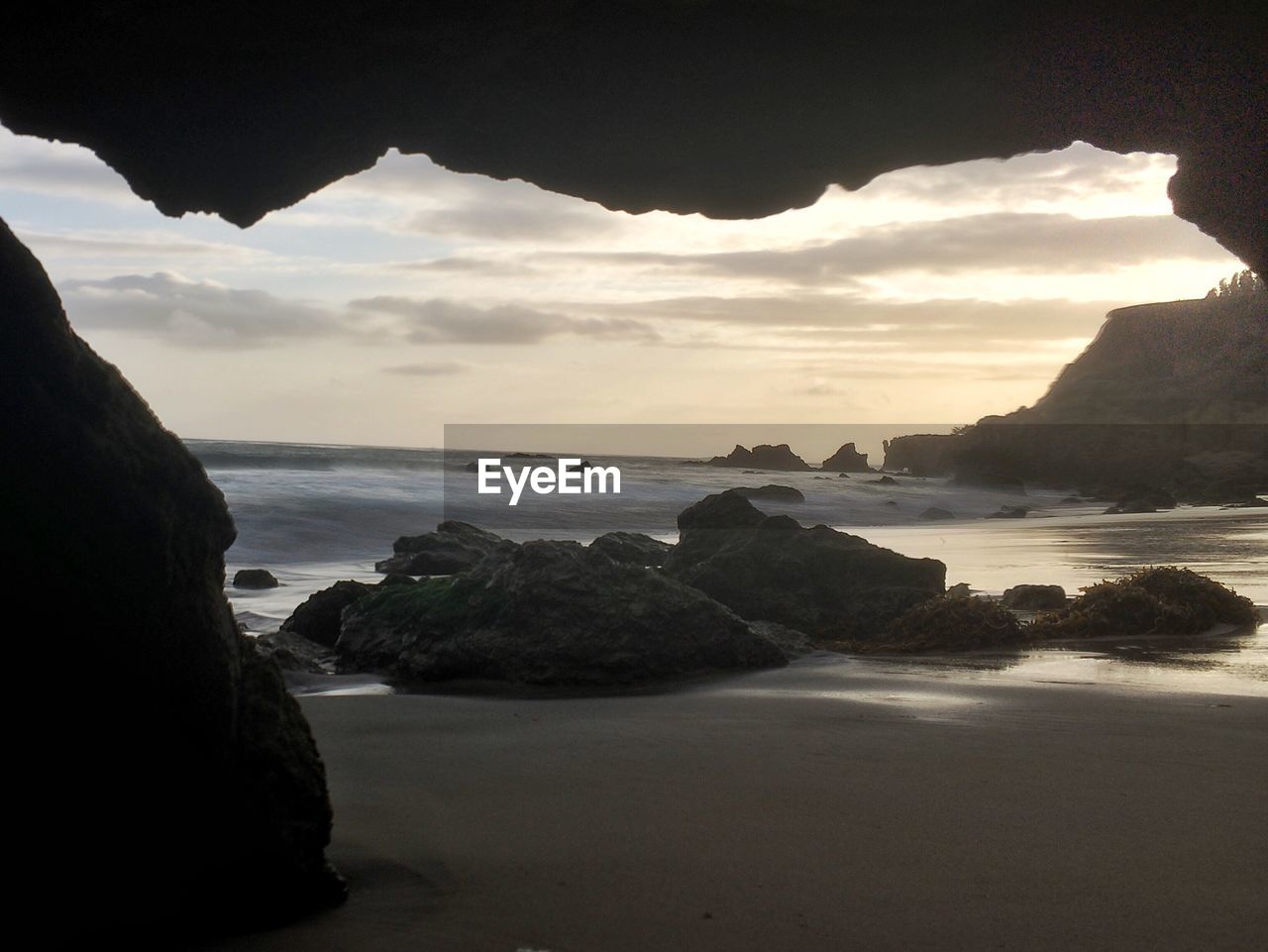 View of beach against cloudy sky