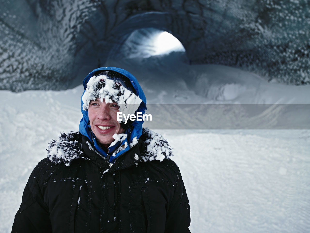 Man exploring ice cave in iceland