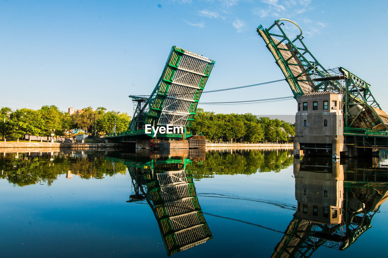 Built structure by lake against sky