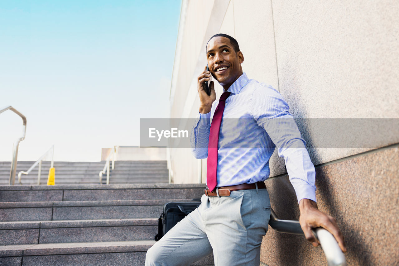 side view of young man using mobile phone