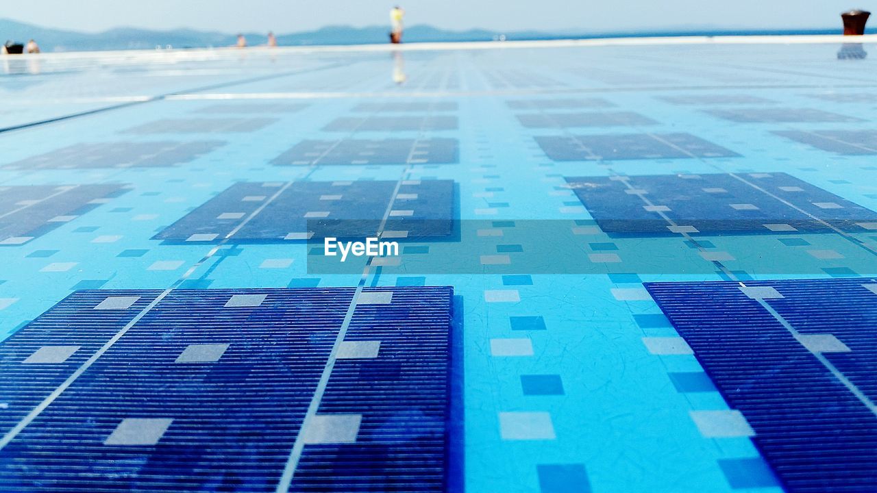 CLOSE-UP OF SWIMMING POOL AGAINST THE SKY